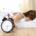 woman_turning_alarm_clock_off-12501-min