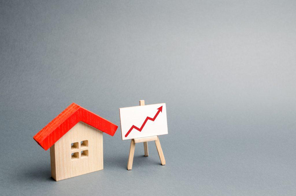 wooden-house-and-stand-with-red-arrow-up compressed