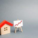 wooden-house-and-stand-with-red-arrow-up compressed