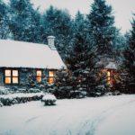 a-house-in-the-snow-surrounded-by-a-forest