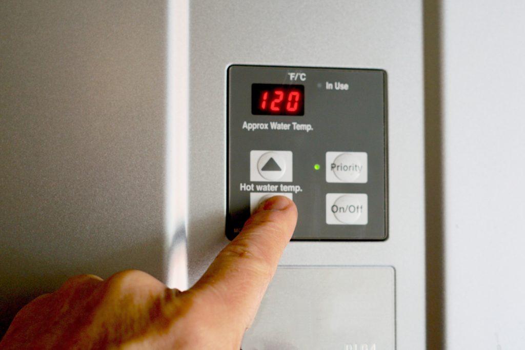 finger-on-hot-water-heater-control-unit