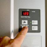 finger-on-hot-water-heater-control-unit