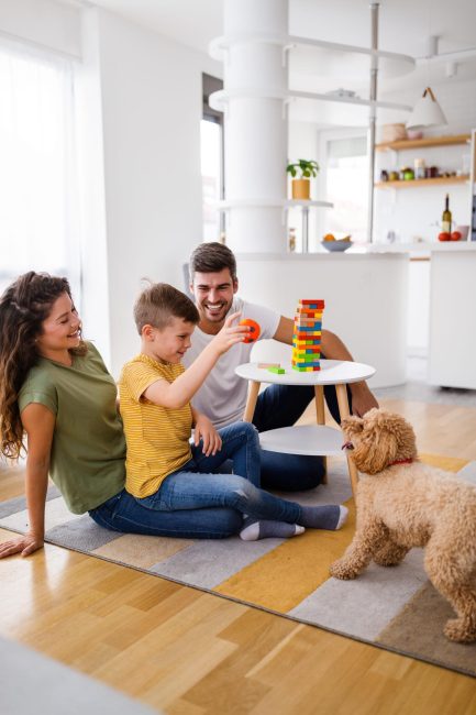 Happy family having fun, playing board game at home, happiness concept. People pet love concept.